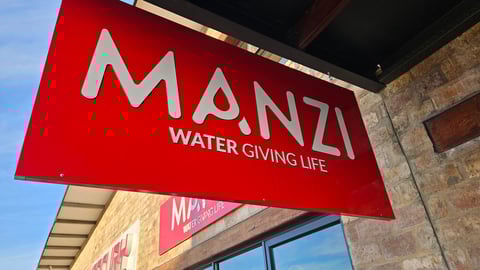 Manzi hanging sign