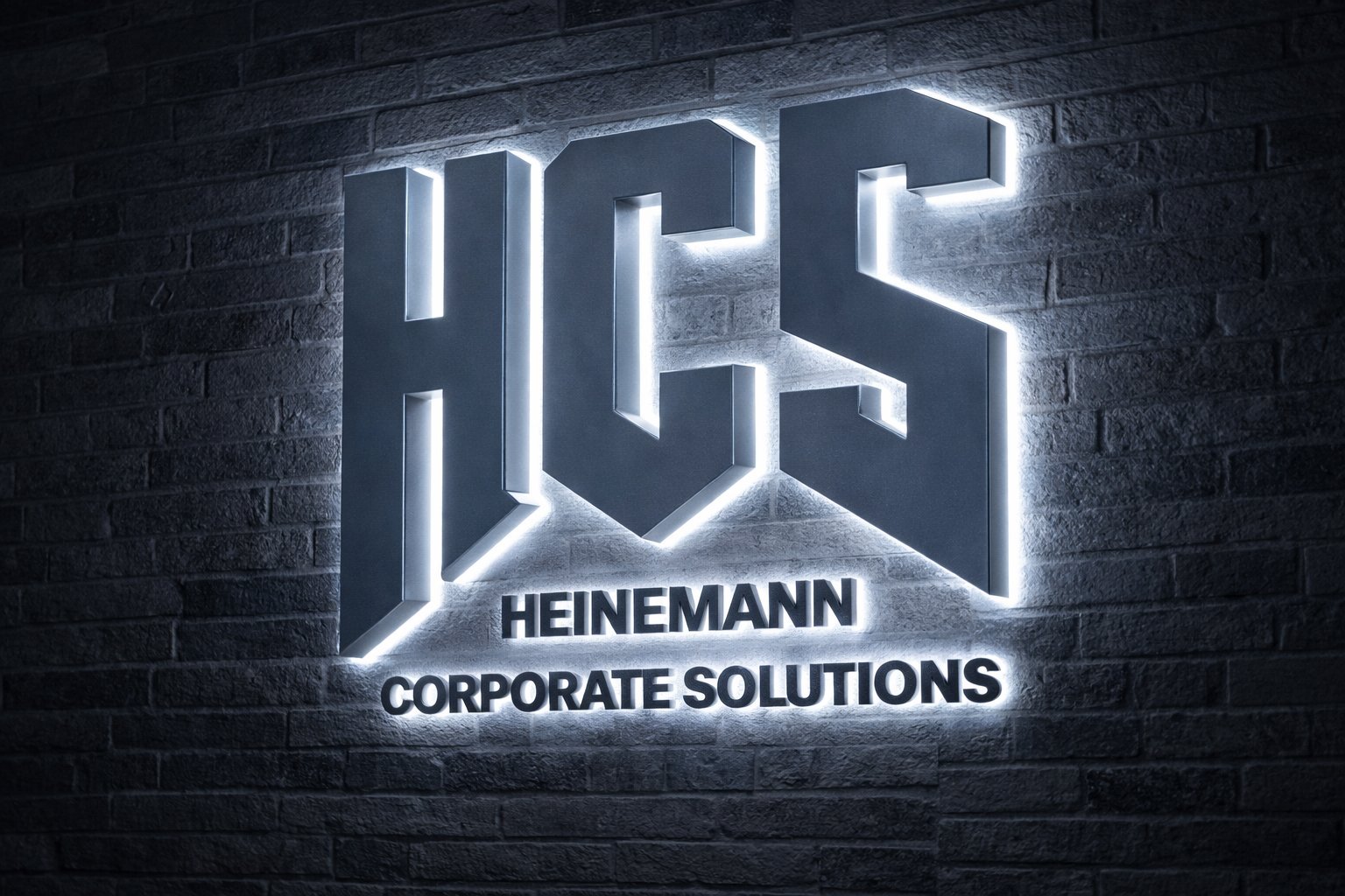 Glowing neon sign displaying HCS Heinemann Corporate Solutions logo on dark brick wall